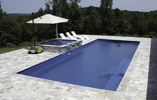 Leisure Pools The Grand rectangular fiberglass composite pool for lounging, installed by Leisure Pools Beaufort